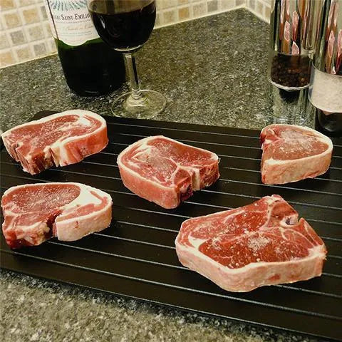 Black aluminium kitchen defrosting tray for thawing frozen meat and food without electricity