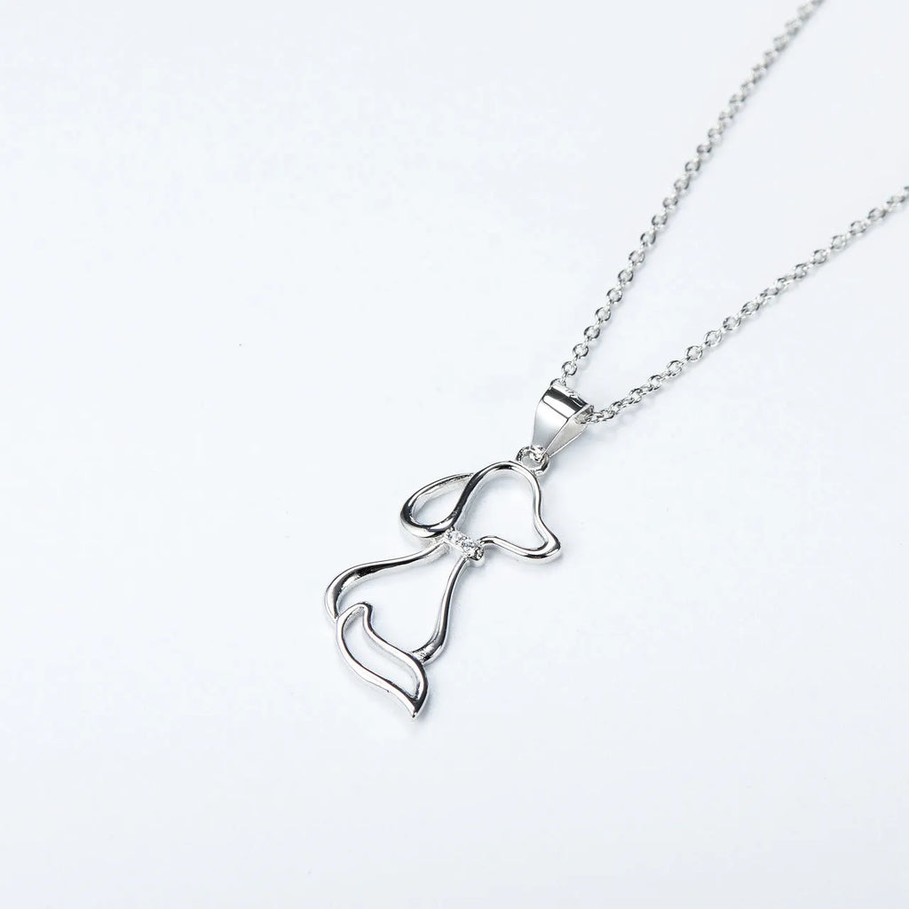 Ladies 925 sterling silver dog pendant necklace with adjustable round bead chain on neutral background