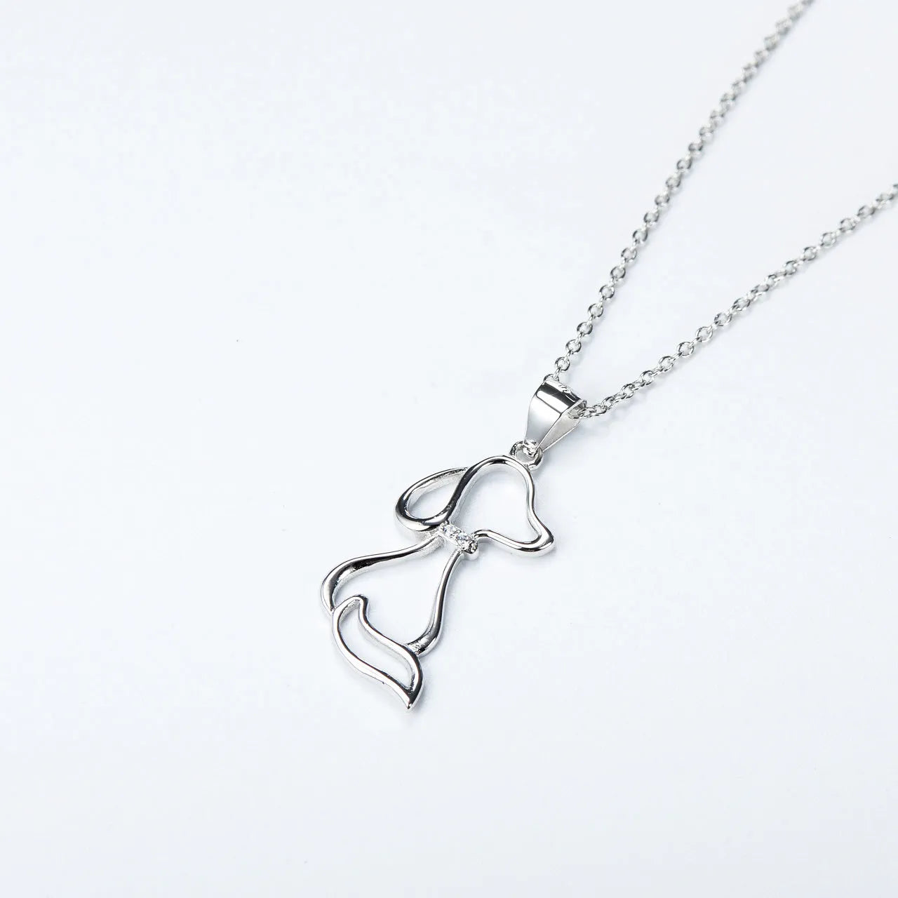 Ladies 925 sterling silver dog pendant necklace with adjustable round bead chain on neutral background