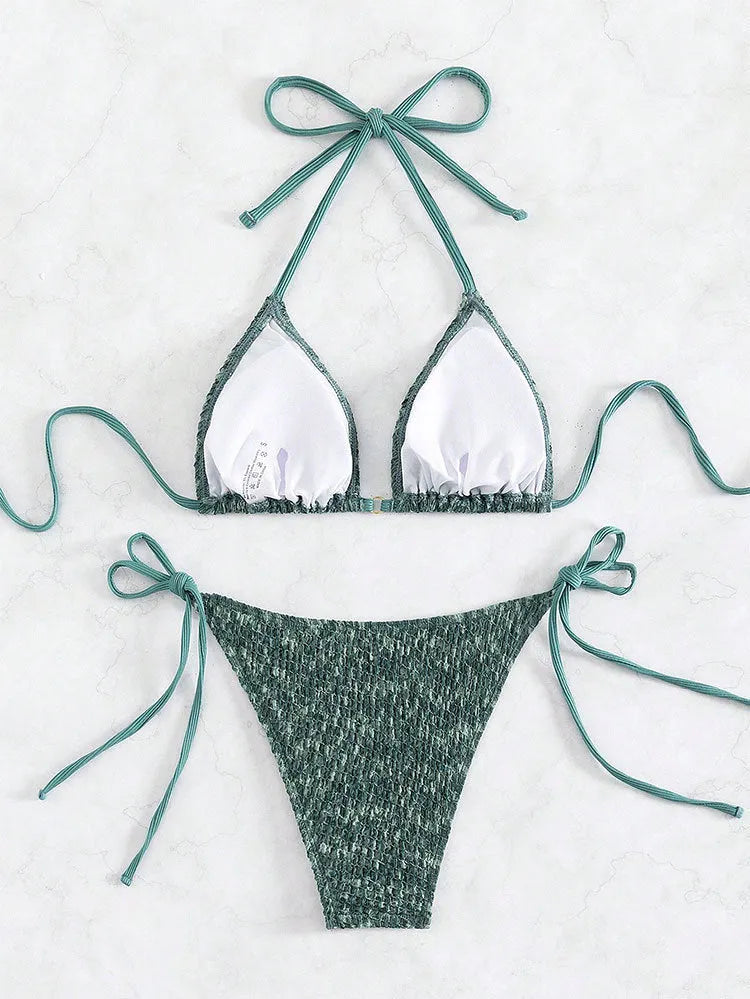 Green women's backless swimsuit with three-point halter strap design showing front and back views