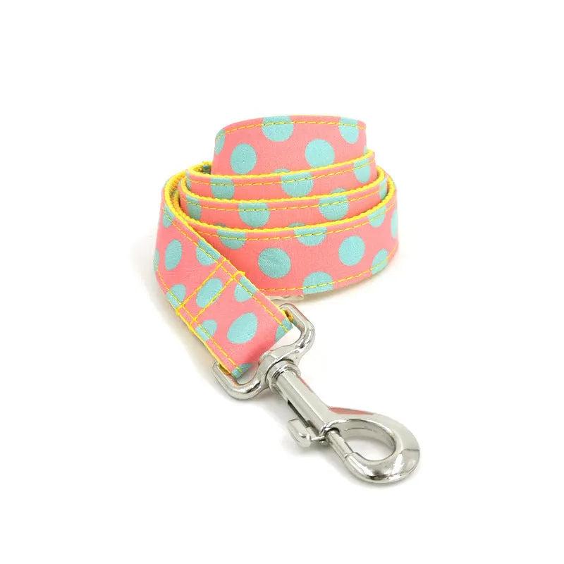 Yellow polka dot dog collar with attached lead rope and fabric bow decoration