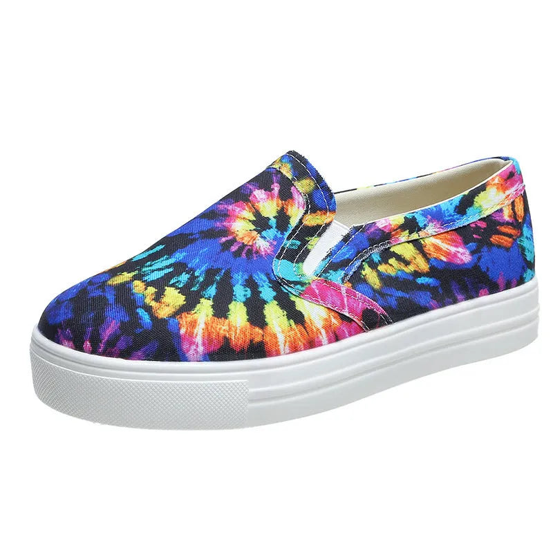 Women's low-top canvas trainers in multiple colours with flat rubber sole.