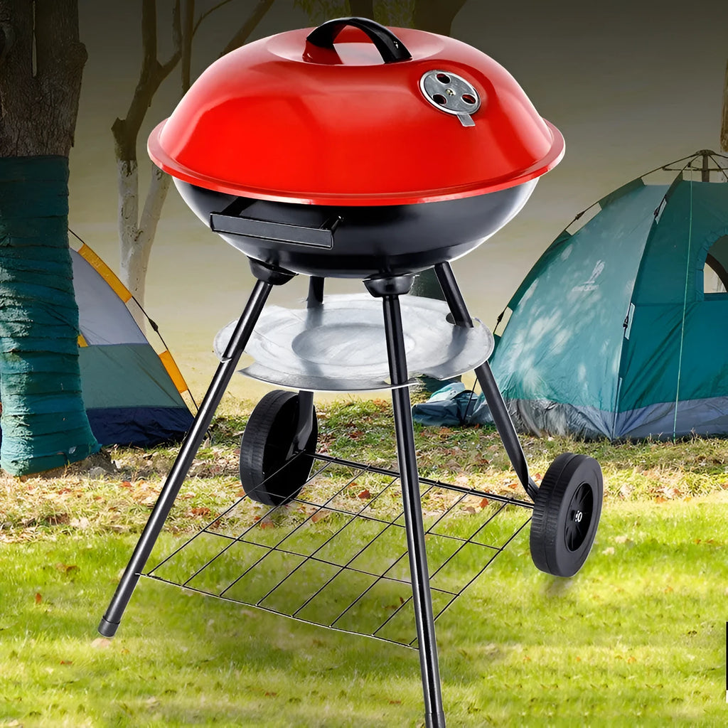 A portable 14-inch diameter iron barbecue grill with an Apple Stove design, shown on a garden patio.