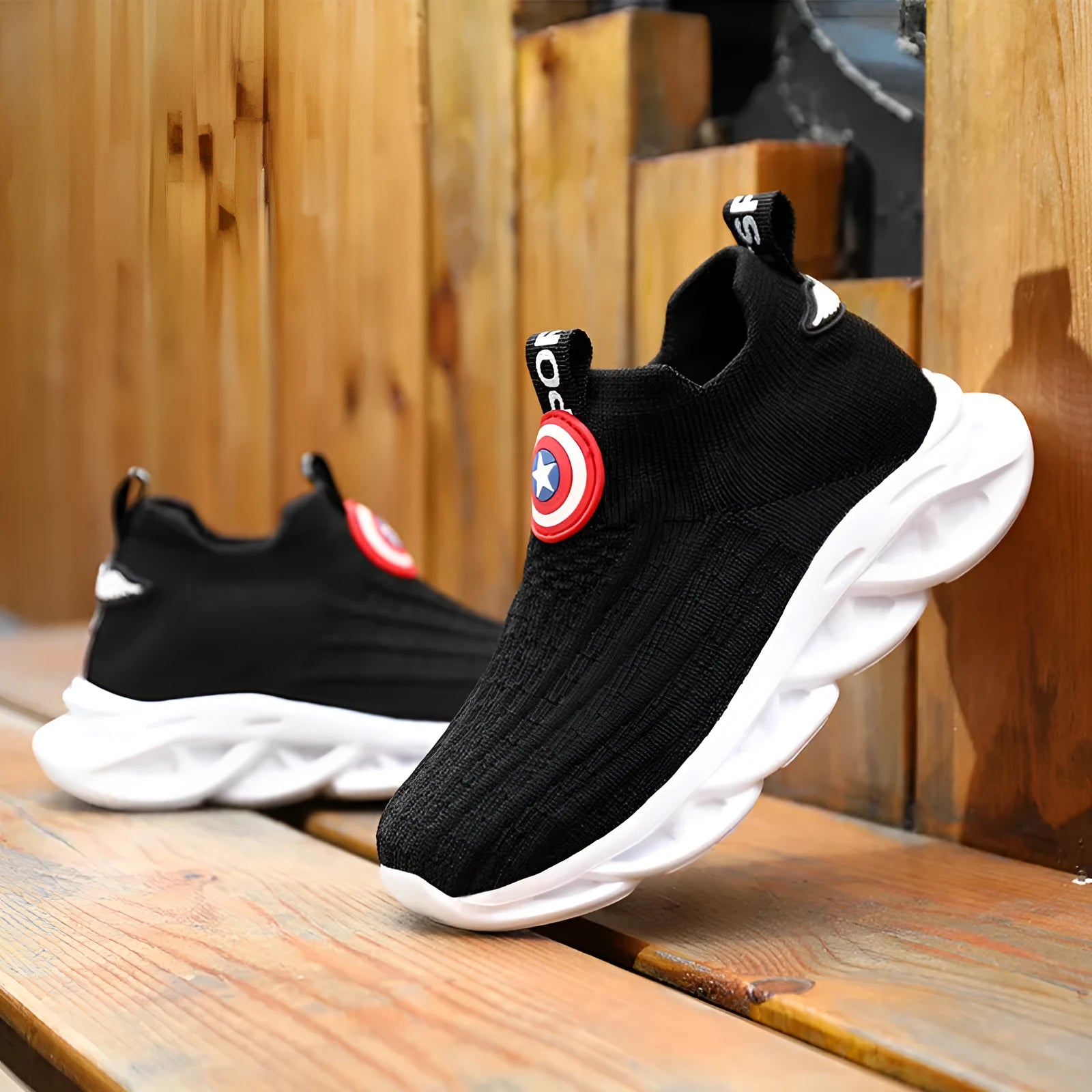 Black and white knitted sleeve-style overshoes with MD sole for runway wear