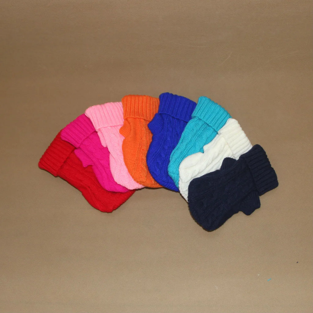Knitted wool dog sweater with fabric buttons on a white background, shown in blue