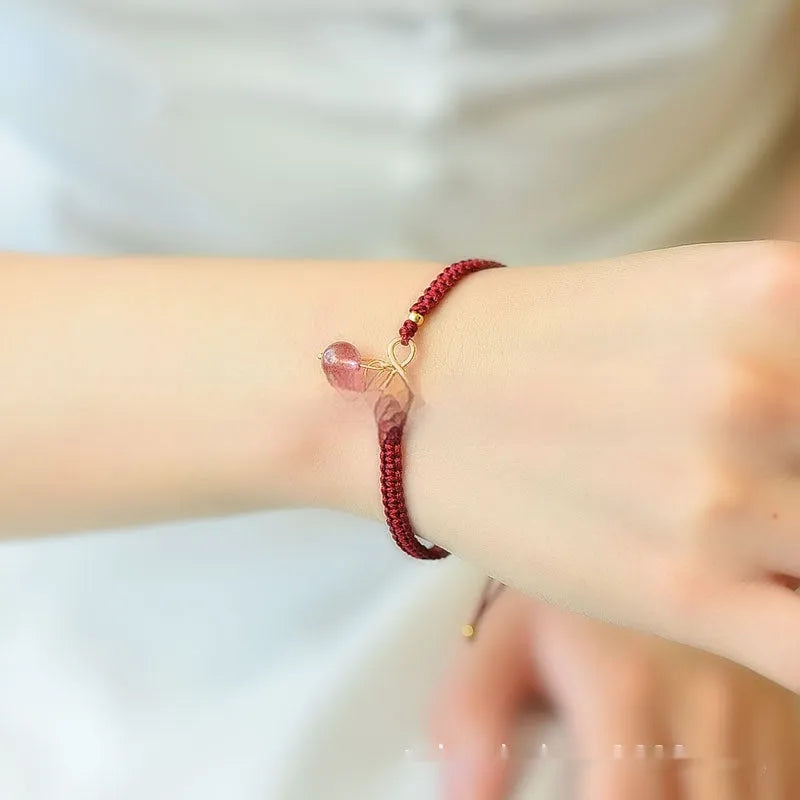 Women's Natural Strawberry Quartz bracelet with a fruit-shaped crystal bead on an elastic cord.