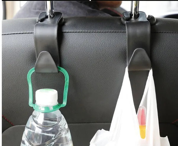 Set of four black PP plastic universal car seat back hooks on a car front seat backrest