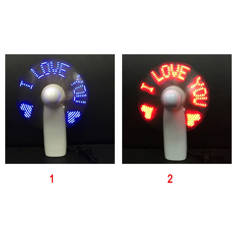White handheld mini fan with flashing blue and red LED 'I Love You' pattern on a dark background.