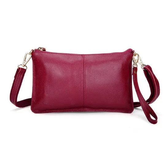A cowhide lady slant bag in a chosen colour, showing hand and shoulder straps, with dimensions of 24 cm by 14 cm.