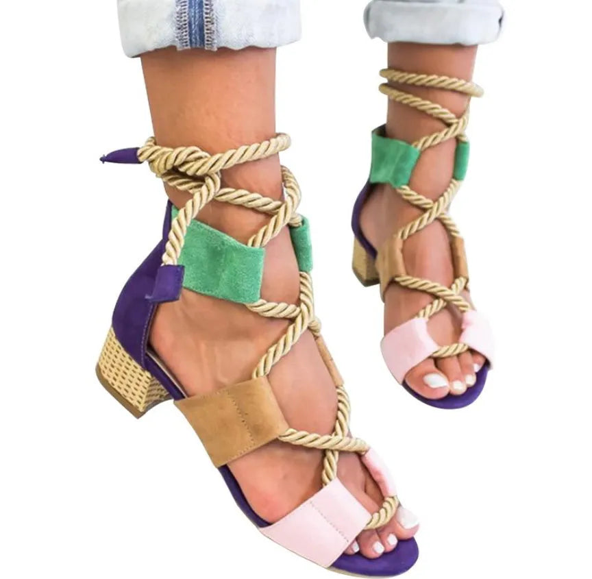 Women's beige suede sandals with front strap, thick middle heel, and ankle strap.