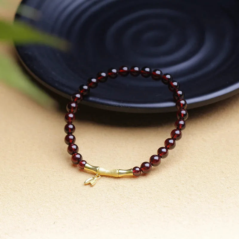 Handmade natural garnet bracelet with a 6mm silver or copper bamboo joint centrepiece.