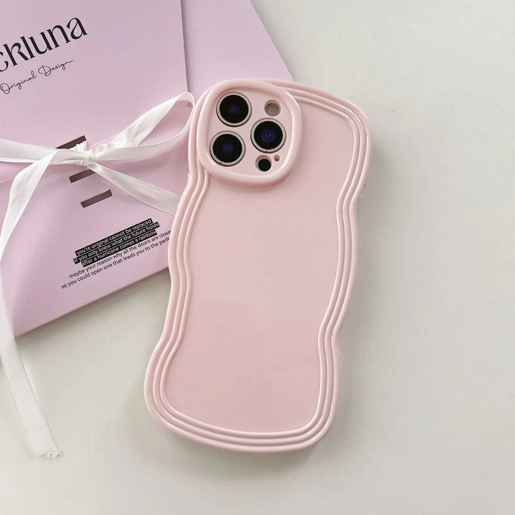 Cream coloured wave texture mobile phone case for iPhone on wooden surface