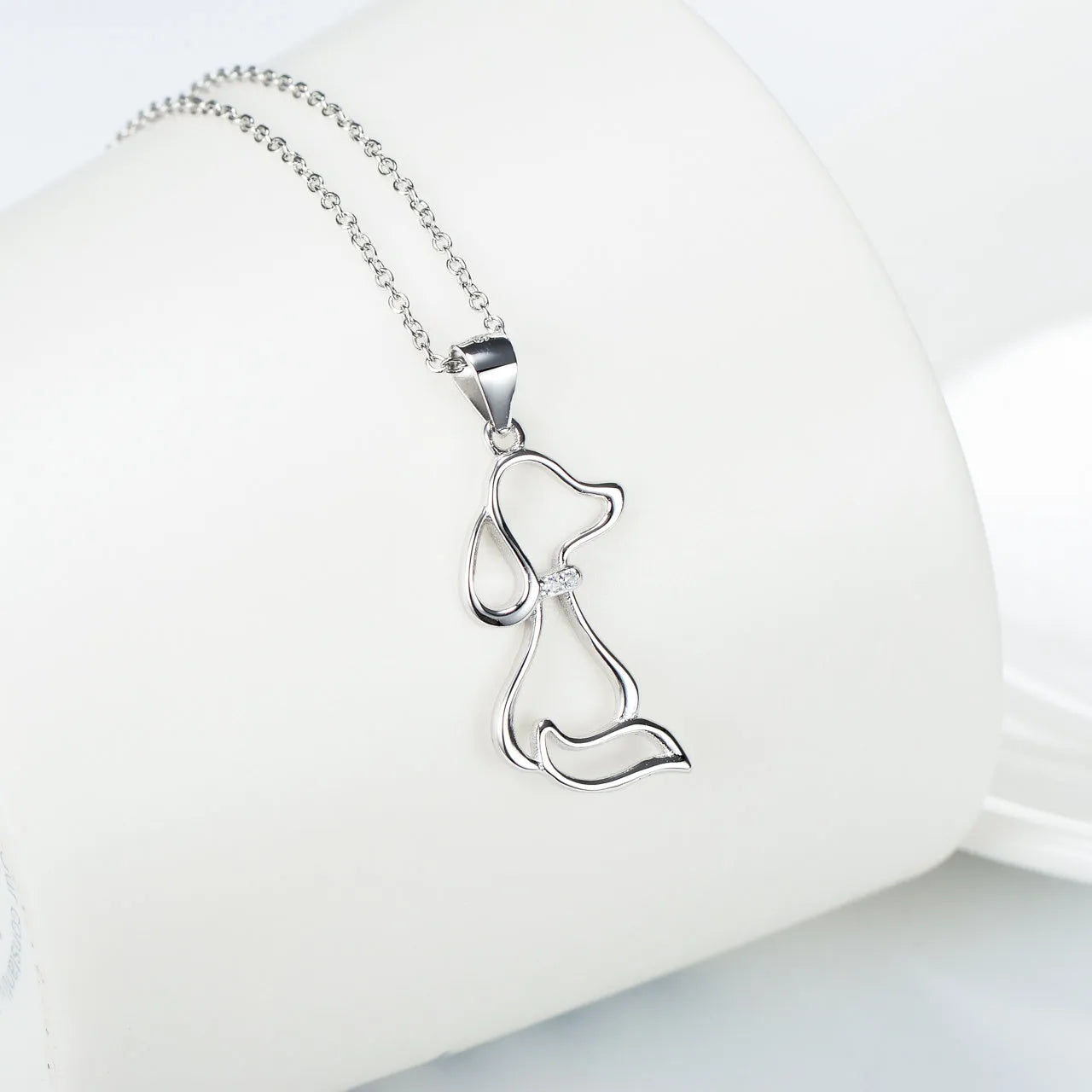 Ladies 925 sterling silver dog pendant necklace with adjustable round bead chain on neutral background