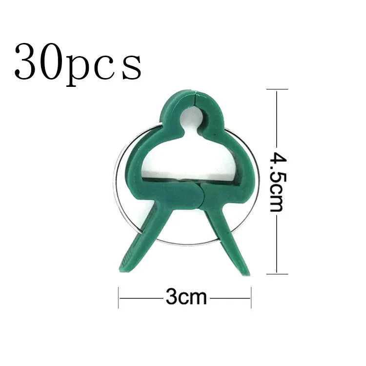 Green plastic and zinc plant fixing clips in large and small sizes for securing tomato vines and climbing plants.