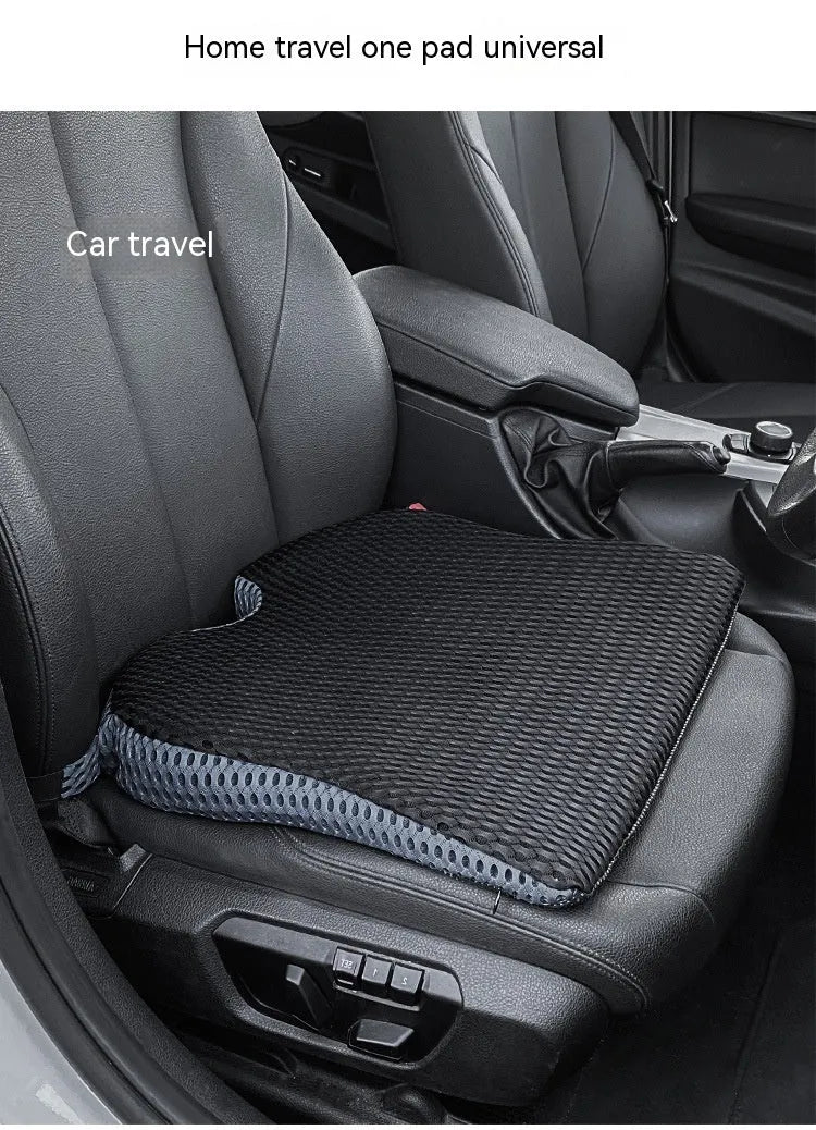 A solid-colour memory foam seat cushion with an adjustable strap, shown in creamy white.
