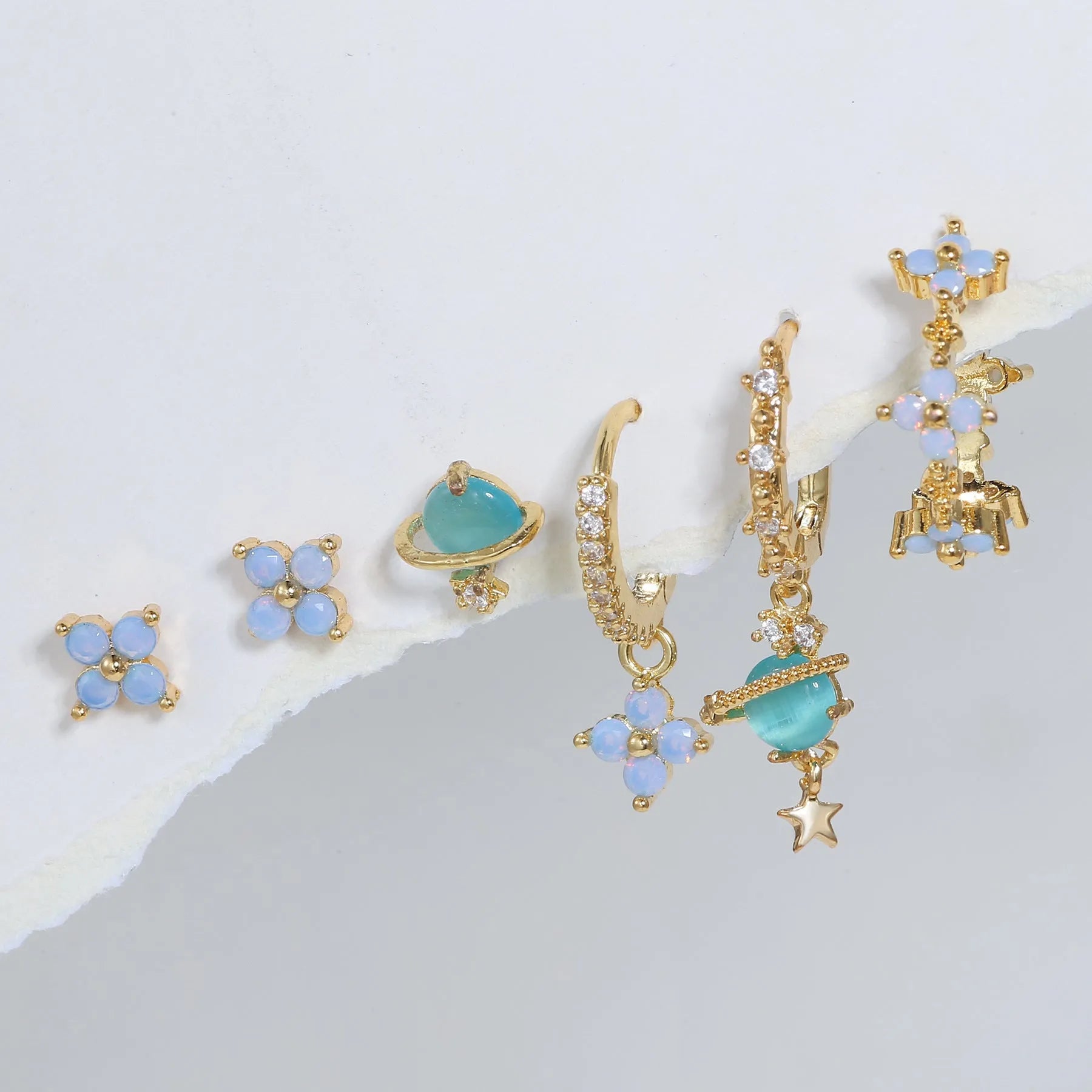 Gold and silver floral ear studs with zircon mosaic details in Japanese Korean style.