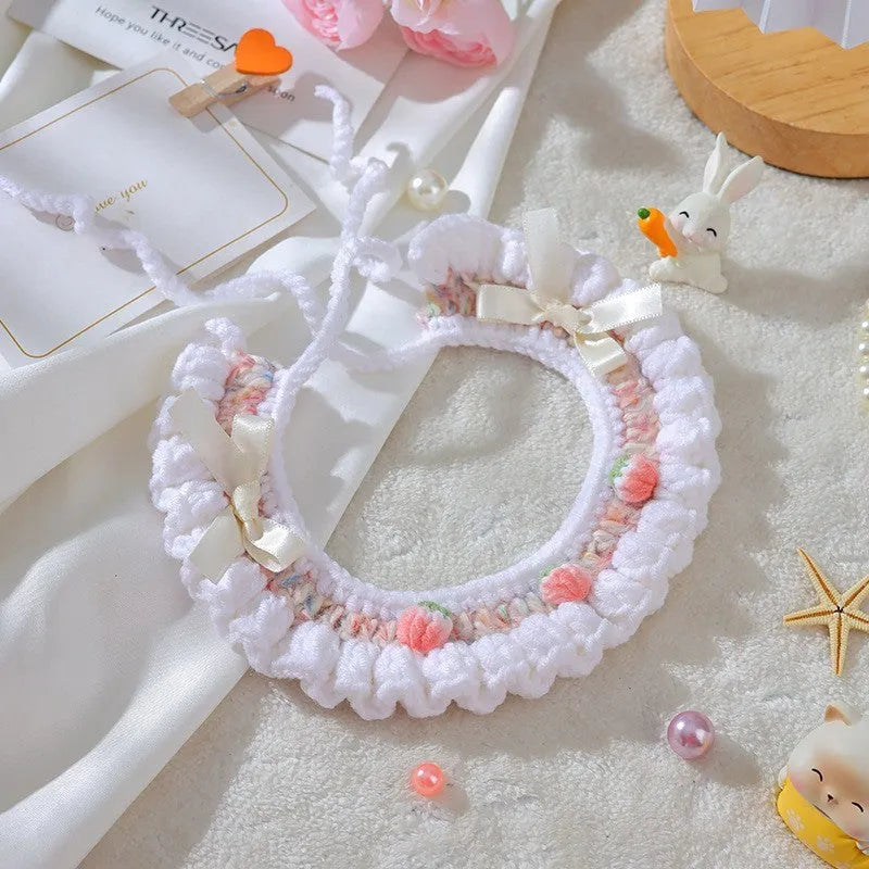 Handmade woven wool cat collar with embroidered cartoon British Shorthair kitten in pink, white, and yellow colours.