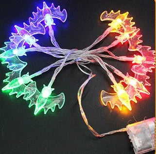 Halloween LED string lights with pumpkin, bat, and ghost decorations hanging on a wall