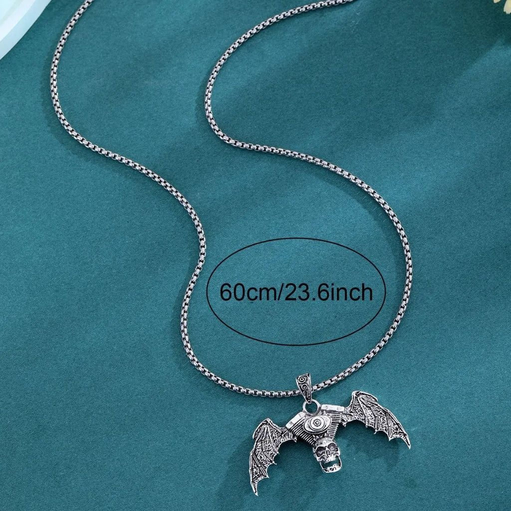 Gothic dark alloy skull pendant necklace with skeleton wing detail on matte black background