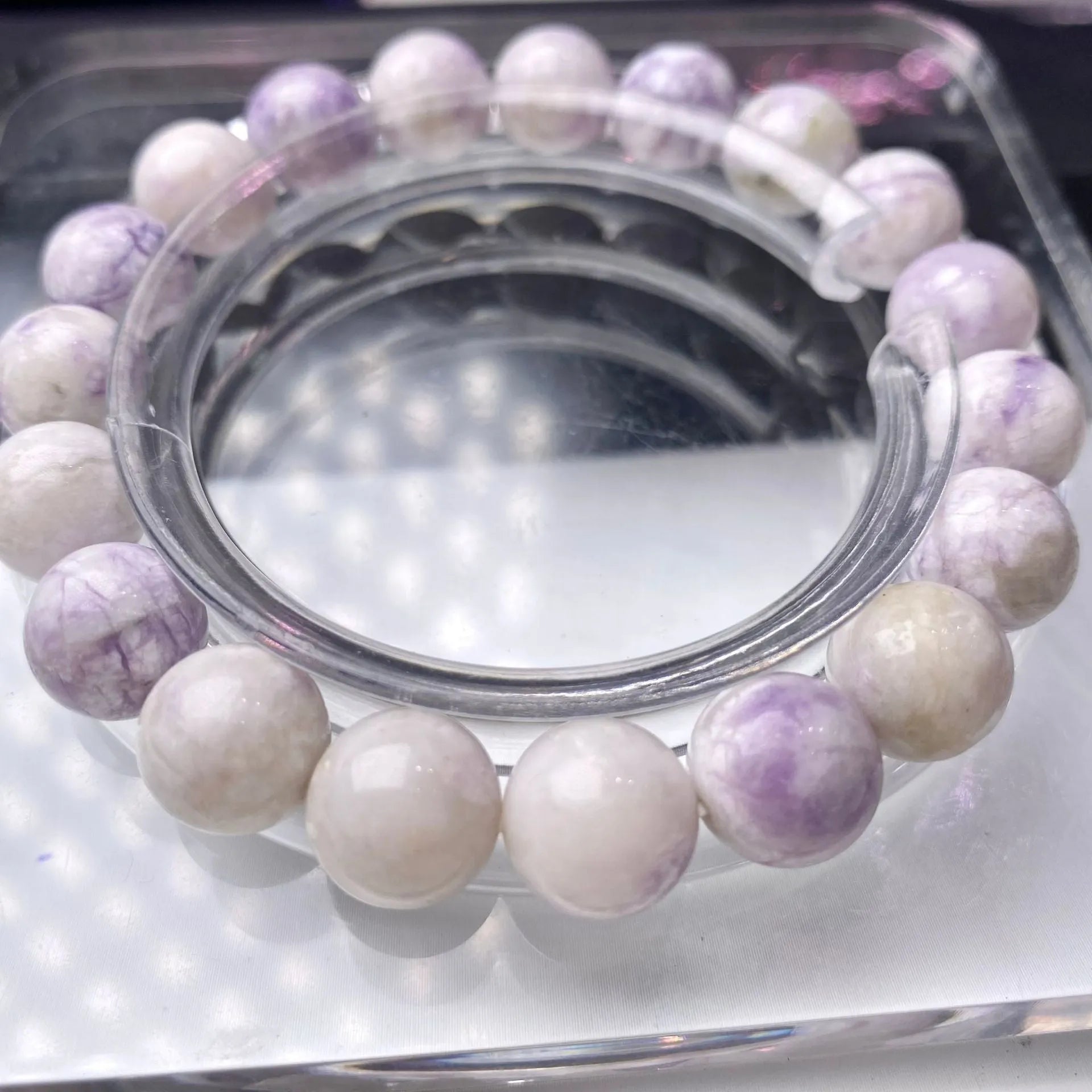 Close-up of a natural purple turquoise beaded bracelet with an adjustable string fastening.