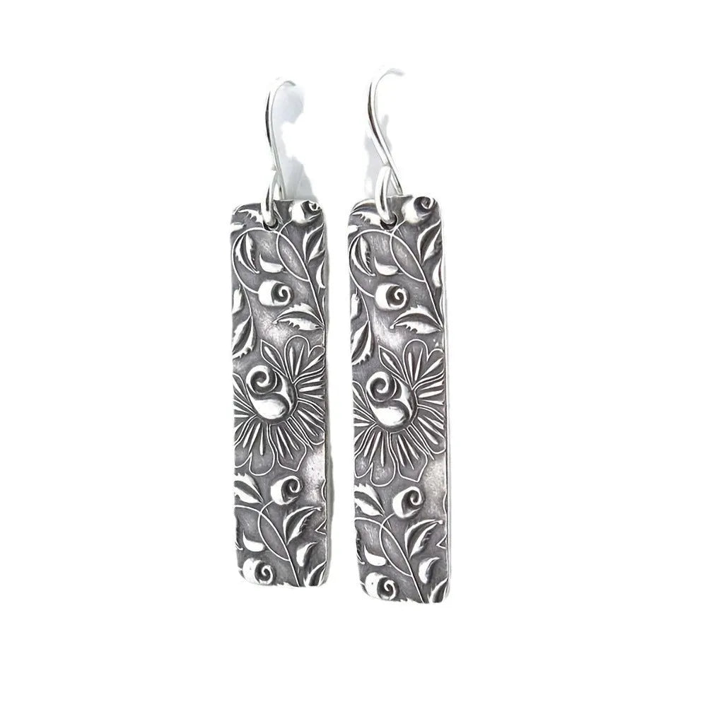 Silver long earrings with geometric shapes and carved vine detailing in zinc alloy construction