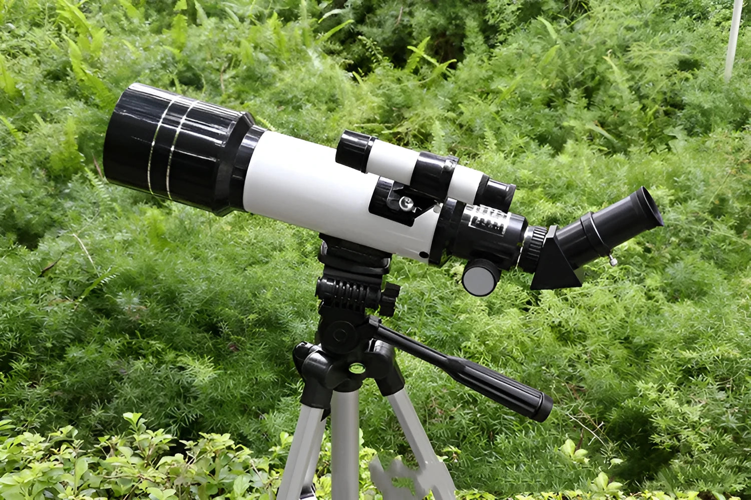 Dark blue children's monocular astronomical telescope with 16X-66X magnification on a tripod.