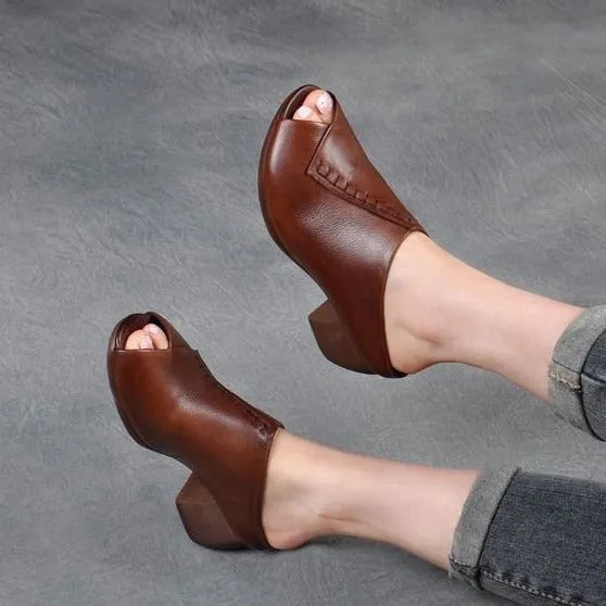 Women's black square heel peep-toe slippers with a fish-mouth scaffold design on a white background.