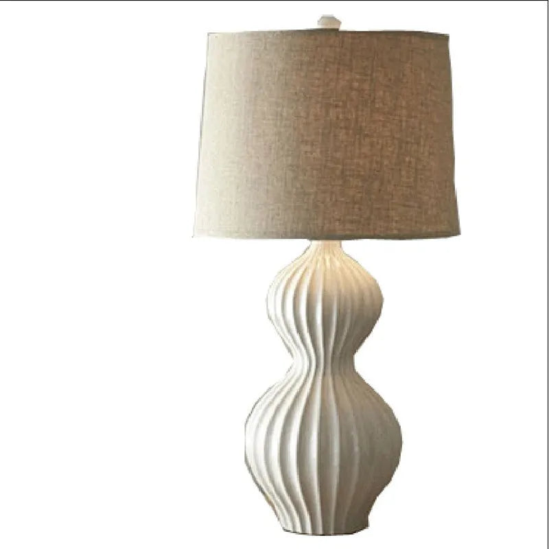 Ceramic base table lamp with fabric shade in country style.