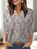 Women's loose-fit grey V-neck t-shirt with a white 3D geometric pattern print on the front.