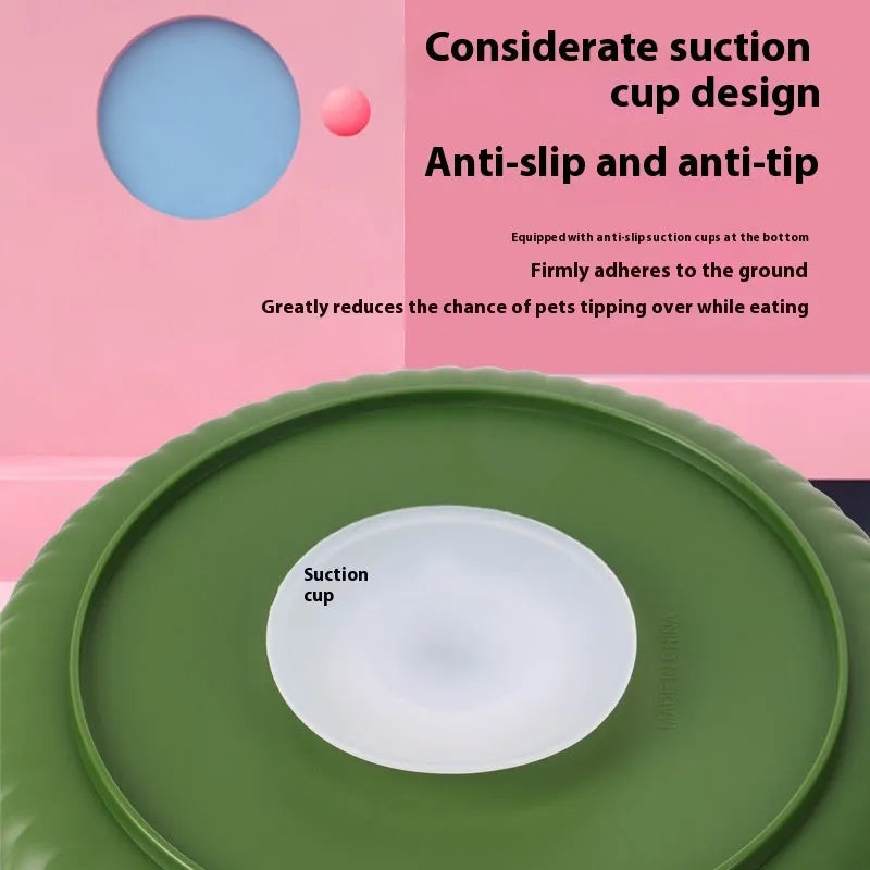 Grey slow feed dog bowl with rotating puzzle disc and a textured, green silicone licking mat in the centre