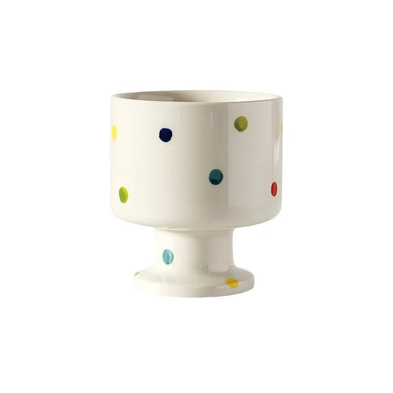 Irregularly shaped hand-pinched ceramic mug in a solid colour, shown on a plain background.
