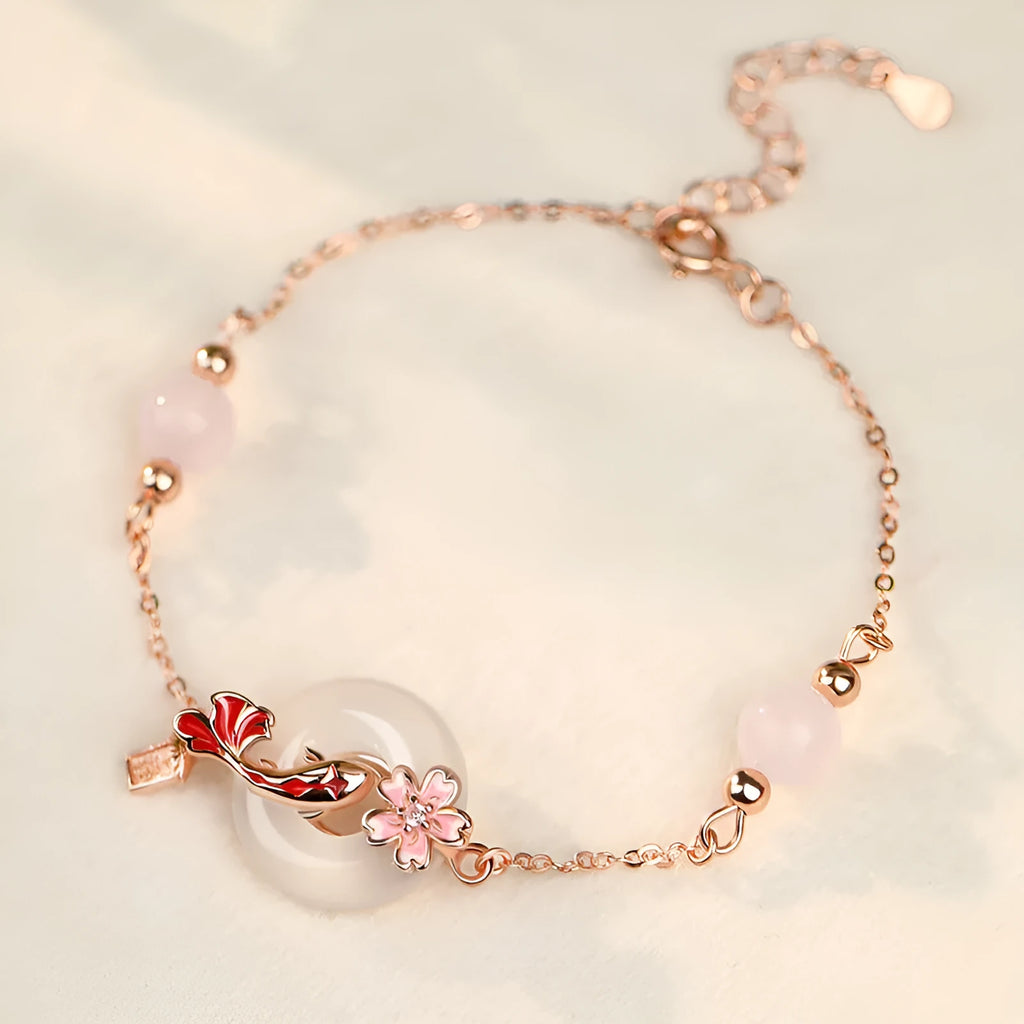Close-up of a women's S925 sterling silver bracelet with a white chalcedony crystal flower and koi-themed design.