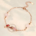 Close-up of a women's S925 sterling silver bracelet with a white chalcedony crystal flower and koi-themed design.
