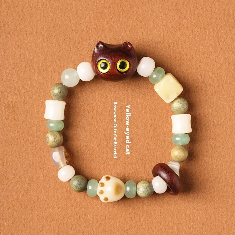 Hand-woven adjustable bracelet with bodhi seeds, jade beads, and a cartoon cat's paw guajacwood charm