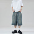 Man wearing light blue straight-leg cropped denim shorts for casual summer wear.