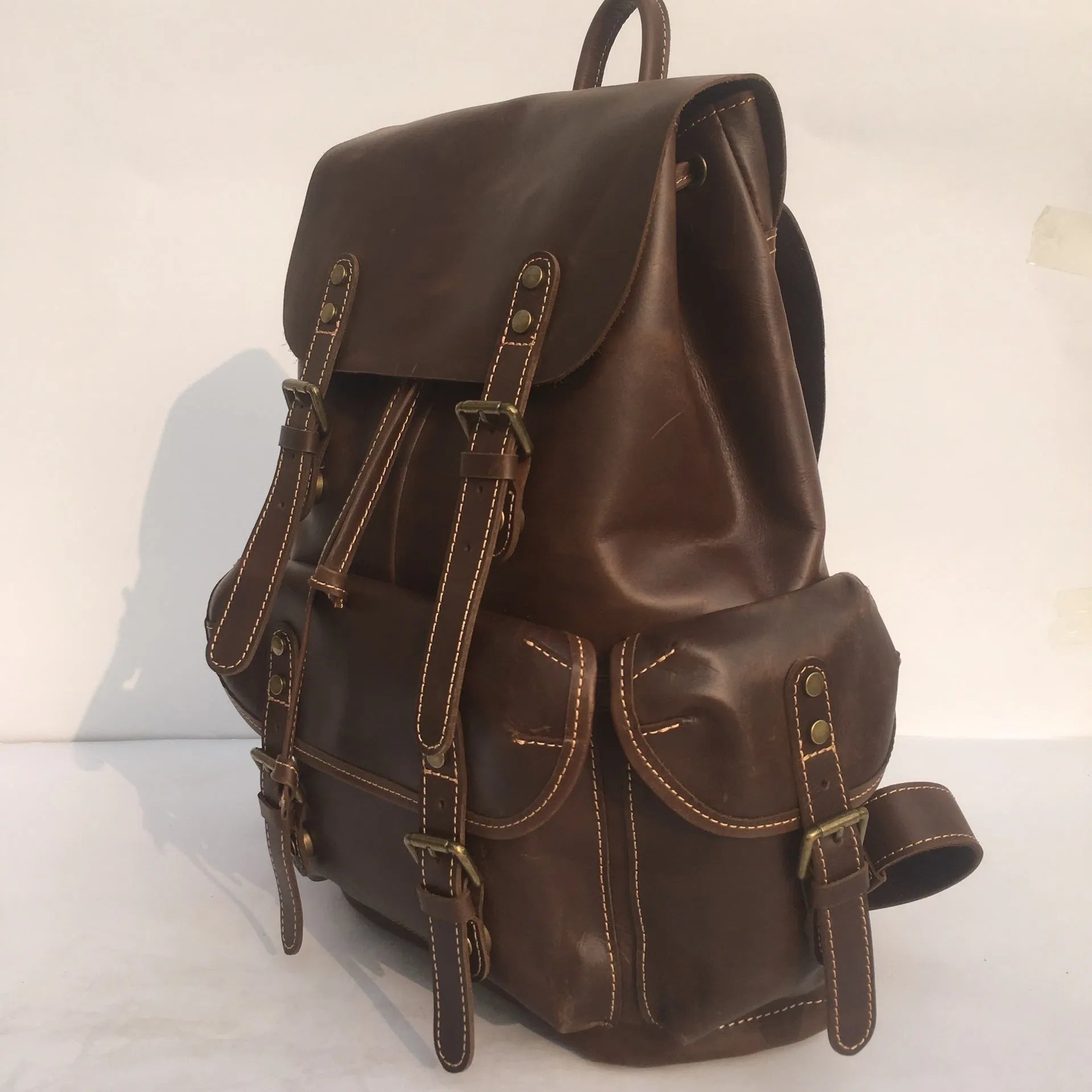 Brown coffee genuine leather men's backpack with air cushion shoulder straps showing first layer cowhide texture