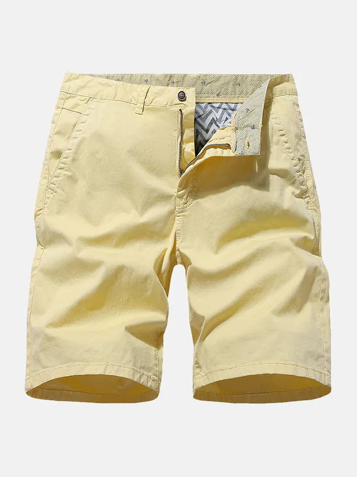 Man wearing blue printed denim casual shorts with a loose, straight leg fit and no belt.