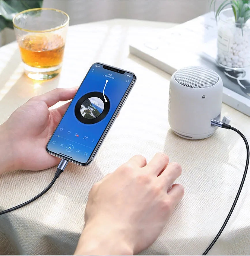 Black Apple Lightning to 3.5mm audio cable with braided TPE coating and aluminium connectors for car use.