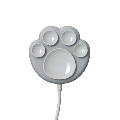 Pink cat claw sucker wireless charger with USB cable on a desk