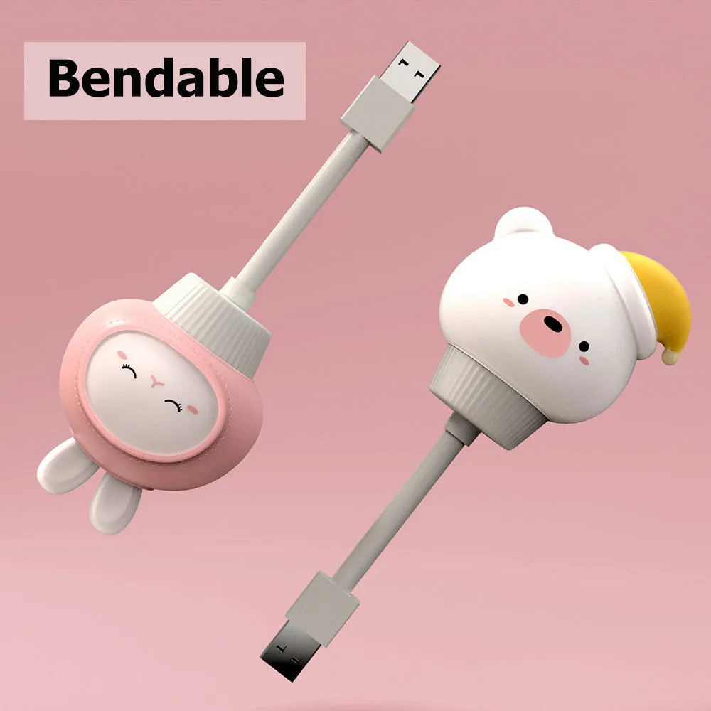 White USB cartoon animal night light in bear design with remote control on wooden table.