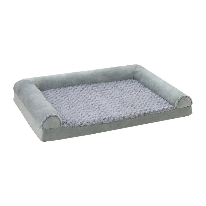 Grey soft-sided dog kennel bed with raised edges, shown in a home setting.