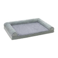 Grey soft-sided dog kennel bed with raised edges, shown in a home setting.