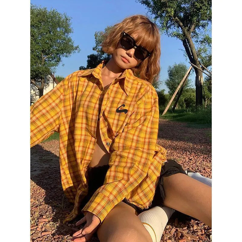 Loose-fit yellow plaid cardigan-style shirt for men and women on a hanger
