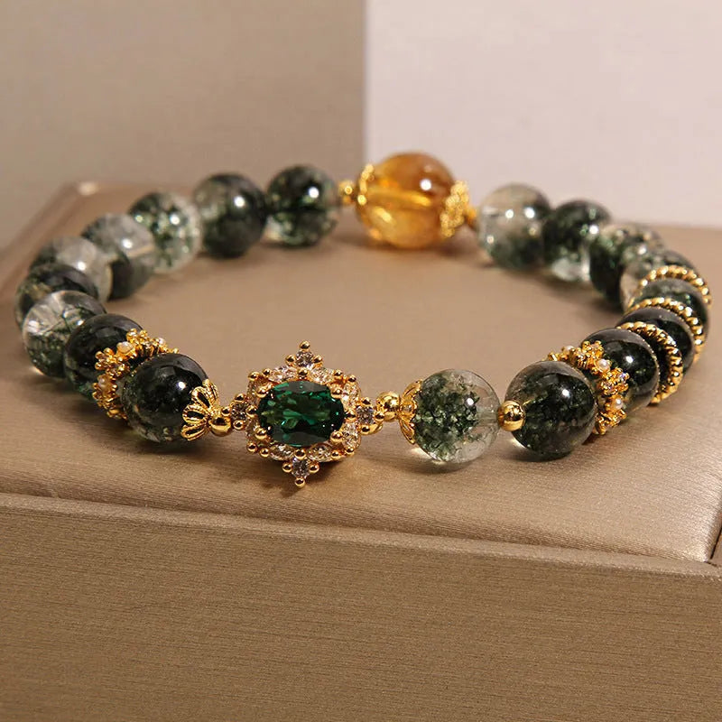 Gold rutilated quartz bracelet with green phantom quartz and ruby quartz crystal beads, pearl accents, and gold-plated detailing