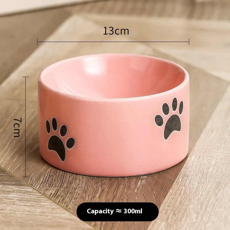 Ceramic cat bowl with cat paw design in black, showing oblique mouth style.