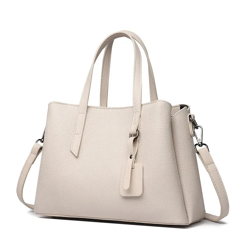 Women's cowhide leather large capacity handbag in horizontal square shape with single shoulder strap.