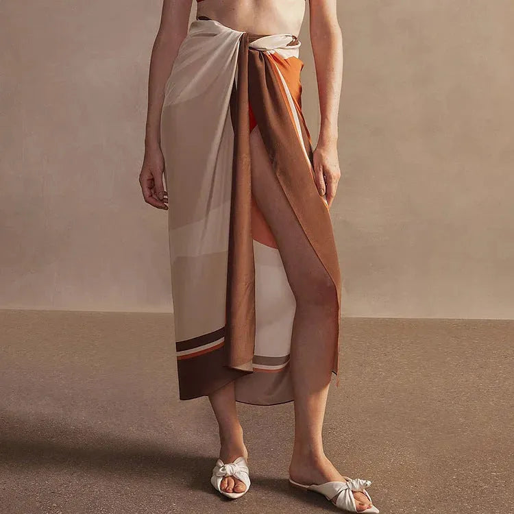 Women's printed dot one-piece swimsuit with a matching wrap skirt, shown on a mannequin.