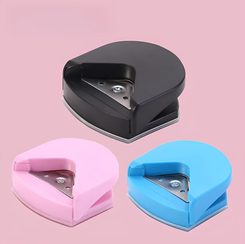 Black plastic and metal business card corner cutter on a white background.