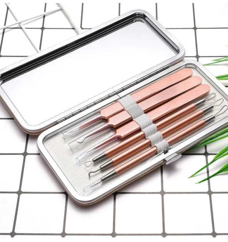 Six rose gold stainless steel acne remover pimple pins on a clean surface.