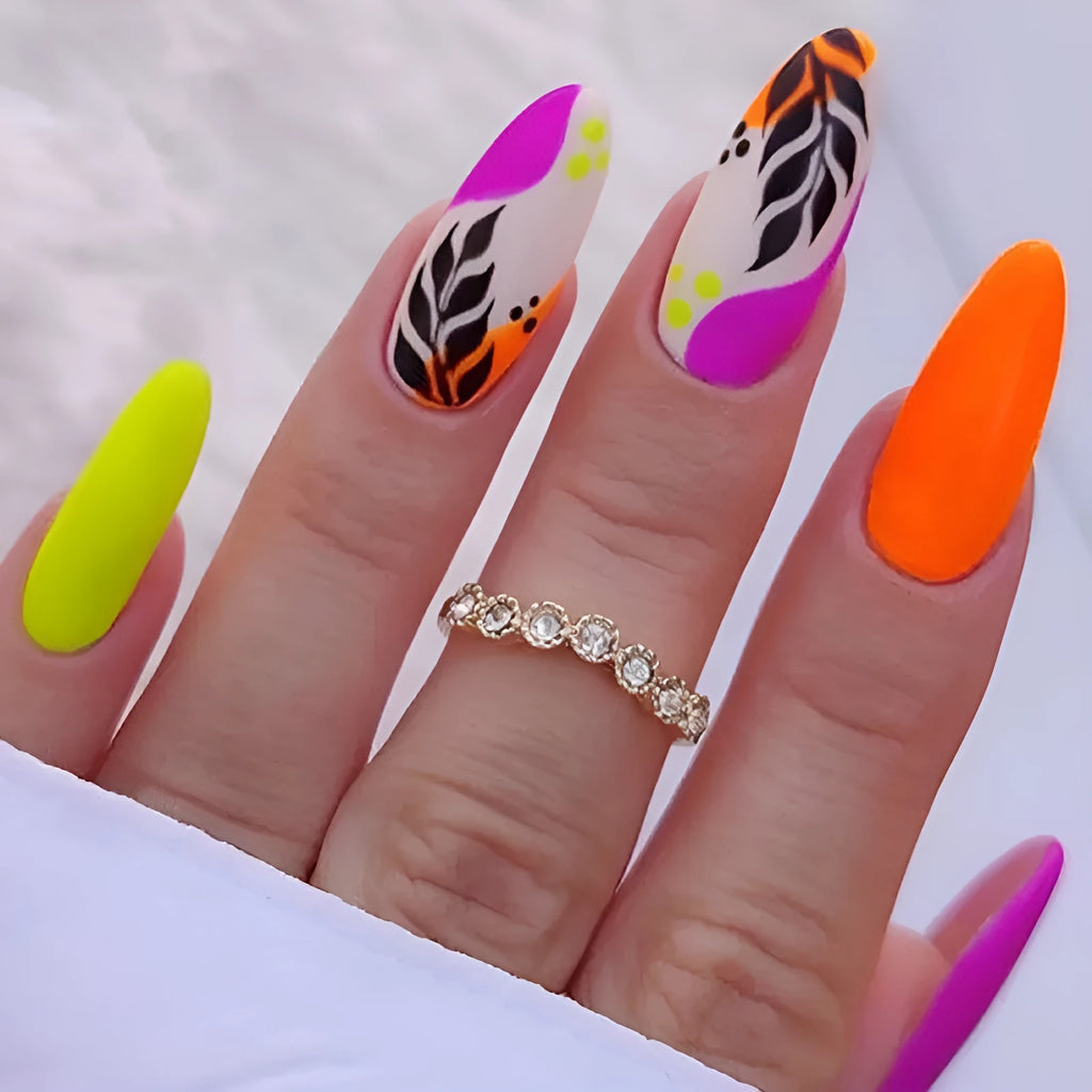 Wear Armour medium almond frosted nail stickers showing French leaves, leopard print, plating, and macaron designs